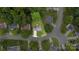 An aerial view of a home nestled in a lush, green neighborhood with mature trees and manicured lawns at 10306 Madison Park Dr, Charlotte, NC 28269