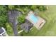 Overhead shot of community pool, clubhouse, and parking area nestled among trees and landscaping at 10306 Madison Park Dr, Charlotte, NC 28269