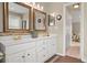 Bright bathroom with double vanity, granite counters, and decorative mirrors at 10306 Madison Park Dr, Charlotte, NC 28269