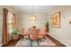 Stylish dining room featuring a glass table, unique chairs, and modern lighting fixtures at 10306 Madison Park Dr, Charlotte, NC 28269