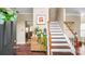 Warm foyer featuring wood floors, stairs, and stylish decor, creating a welcoming entrance at 10306 Madison Park Dr, Charlotte, NC 28269