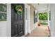 Close up of front door with a 'Welcome' wreath, and inviting porch details at 10306 Madison Park Dr, Charlotte, NC 28269
