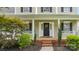 Inviting front porch with a welcoming wreath and manicured landscaping at 10306 Madison Park Dr, Charlotte, NC 28269