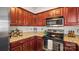Well-maintained kitchen with granite countertops, stainless appliances, and cherry cabinets at 10306 Madison Park Dr, Charlotte, NC 28269