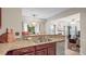Kitchen view of granite counters, stainless dishwasher, and a passthrough to the living room at 10306 Madison Park Dr, Charlotte, NC 28269