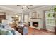 Comfortable living room features a fireplace, hardwood floors, and views of the kitchen at 10306 Madison Park Dr, Charlotte, NC 28269