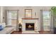 Inviting living room with a cozy fireplace and large windows for natural light at 10306 Madison Park Dr, Charlotte, NC 28269