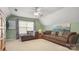 Spacious living room with vaulted ceiling, plush seating, and a cozy atmosphere at 10306 Madison Park Dr, Charlotte, NC 28269