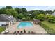 Aerial view of community pool with lounge chairs and gazebo, surrounded by lush greenery and a secure fence at 10306 Madison Park Dr, Charlotte, NC 28269