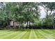 Beautiful treehouse surrounded by mature trees and meticulously striped lawn at 104 Laura Ct, Cherryville, NC 28021