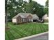 Charming brick home with manicured lawn, attached garage, and inviting curb appeal at 104 Laura Ct, Cherryville, NC 28021