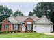 Charming brick home featuring a well-manicured lawn and an attached two-car garage at 104 Laura Ct, Cherryville, NC 28021