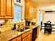 Well-lit kitchen features granite counters, oak cabinets, and stainless steel appliances at 104 Laura Ct, Cherryville, NC 28021