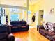 Open-concept living room featuring hardwood floors, large windows, and comfortable seating at 104 Laura Ct, Cherryville, NC 28021