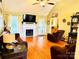 Comfortable living room featuring hardwood floors, a fireplace, and ample natural light at 104 Laura Ct, Cherryville, NC 28021