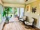 Bright sunroom with rocking chairs, wood-look flooring, and a view of the outdoors at 104 Laura Ct, Cherryville, NC 28021