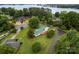 An aerial view shows the home with a green roof and lush trees near the water at 105 Pelican Ct, Mooresville, NC 28117