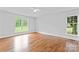 Large bedroom with hardwood floors, two windows and neutral walls at 105 Pelican Ct, Mooresville, NC 28117