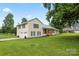 Charming home featuring an attached garage, a covered front porch, and beautiful lawn at 105 Pelican Ct, Mooresville, NC 28117