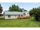Inviting home featuring a rear deck with a metal roof and a spacious backyard at 105 Pelican Ct, Mooresville, NC 28117