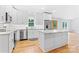 Eat-in kitchen boasts stainless appliances, white subway tile backsplash, and marble counters at 105 Pelican Ct, Mooresville, NC 28117