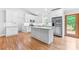 Modern white kitchen featuring an island, stainless steel appliances, and granite countertops at 105 Pelican Ct, Mooresville, NC 28117