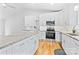 Modern kitchen with stainless steel appliances, granite countertops, and an eat-in island at 105 Pelican Ct, Mooresville, NC 28117