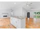 Spacious living room with fireplace, ceiling fans, and a kitchen island perfect for entertaining at 105 Pelican Ct, Mooresville, NC 28117
