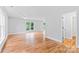 Spacious living room with wood floors, ceiling fan, and bright windows allowing for ample natural light at 105 Pelican Ct, Mooresville, NC 28117