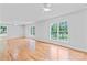 Bright living room with hardwood floors and windows showcasing a green outdoor view at 105 Pelican Ct, Mooresville, NC 28117