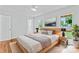 Main bedroom with natural light, hardwood floors, and an ensuite bathroom at 105 Pelican Ct, Mooresville, NC 28117