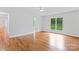 Large bedroom with hardwood floors, view to bath and neutral walls at 105 Pelican Ct, Mooresville, NC 28117
