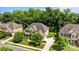 An aerial view features the brick home with mature landscaping, a driveway with a basketball hoop at 10508 Kristens Mare Dr, Charlotte, NC 28277