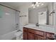 Well-lit bathroom featuring a shower-tub combo and dark wood vanity at 10508 Kristens Mare Dr, Charlotte, NC 28277