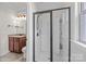Bathroom featuring a sleek glass-enclosed shower and a vanity with decorative lighting and granite countertops at 10508 Kristens Mare Dr, Charlotte, NC 28277