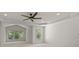 Spacious bedroom with natural light, ceiling fan, and windows that provide a serene view of the surrounding greenery at 10508 Kristens Mare Dr, Charlotte, NC 28277
