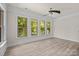 Serene bedroom with ample natural light from the many windows and hardwood floors at 10508 Kristens Mare Dr, Charlotte, NC 28277