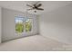 Sunny bedroom featuring double windows with natural light, carpeted floor, and modern ceiling fan at 10508 Kristens Mare Dr, Charlotte, NC 28277