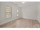 Bright and airy bedroom featuring hardwood floors and natural light from large windows at 10508 Kristens Mare Dr, Charlotte, NC 28277