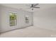Spacious bedroom with carpet, ceiling fan, and sunny windows at 10508 Kristens Mare Dr, Charlotte, NC 28277