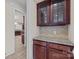 Butler's pantry with granite countertop and dark wood cabinets at 10508 Kristens Mare Dr, Charlotte, NC 28277