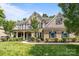 Attractive brick home boasts a manicured lawn, covered entry, and balcony at 10508 Kristens Mare Dr, Charlotte, NC 28277