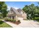 Charming brick home featuring manicured landscaping, a two-car garage, and a basketball hoop on the driveway at 10508 Kristens Mare Dr, Charlotte, NC 28277