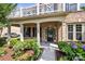 Home featuring a charming porch and front yard with flowers and shrubs at 10508 Kristens Mare Dr, Charlotte, NC 28277