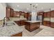 Beautiful kitchen with stainless appliances, granite countertops, large island with pendant lights and hardwood floors at 10508 Kristens Mare Dr, Charlotte, NC 28277