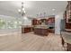 Open-concept kitchen with an island, stainless steel appliances, granite countertops, and hardwood floors at 10508 Kristens Mare Dr, Charlotte, NC 28277
