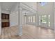 Open floor plan living area with high ceilings, hardwood floors, and large windows at 10508 Kristens Mare Dr, Charlotte, NC 28277