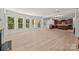 Spacious living room open to the kitchen, featuring hardwood floors and large windows for natural light at 10508 Kristens Mare Dr, Charlotte, NC 28277