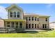 Expansive backyard featuring lush grass, a garden area, and a back patio with large brick home at 10508 Kristens Mare Dr, Charlotte, NC 28277