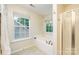 Serene bathroom with soaking tub, glass enclosed shower, and bright window at 10732 Trolley Run Dr, Cornelius, NC 28031